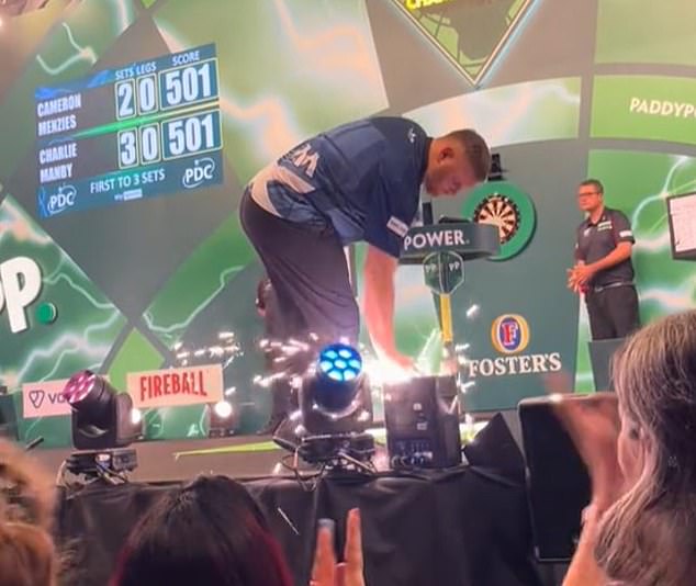 Menzies was also seen covering the on-stage pyrotechnics cannon with his hand as it fizzed