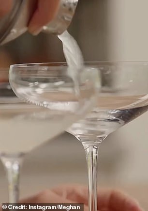 Meghan is seen pouring drinks