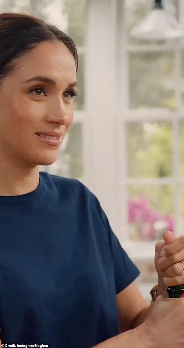 Meghan is seen in her post opening a bottle as she prepares for Christmas