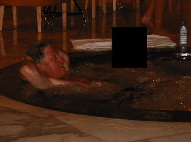 Another photo shows Clinton in a hot tub with a woman whose face was redacted. The files do not say when or where the photos were taken and there was little context surrounding them