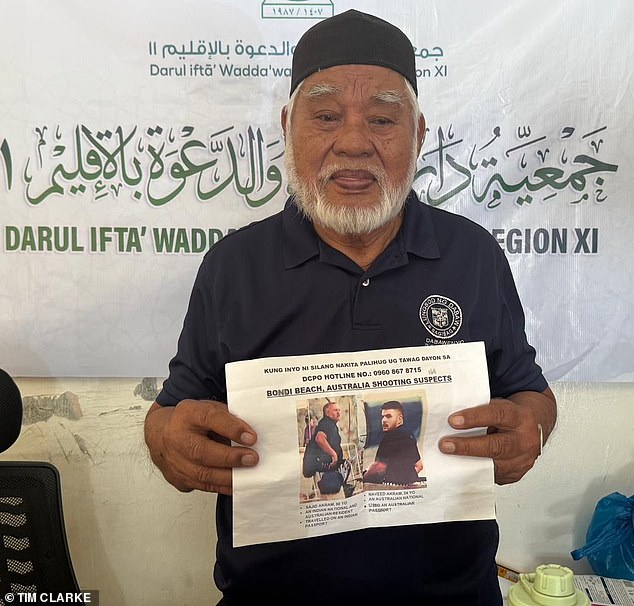 Shaykh Muhammed Yusop Pasigan, regional Grand Mufti, holds up one of the posters of the Akram men have been put up across the 70 mosques in the city of Davao in hopes of gaining some more information on their movements in the Philippines