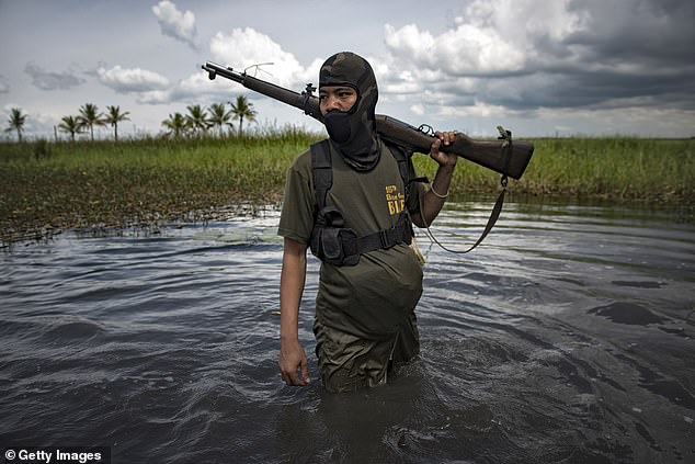 The southern Philippines is now a key node in the global jihadist movement. A Moro Islamic Liberation Front Fighter walks through a marshland in Maguindanao Province