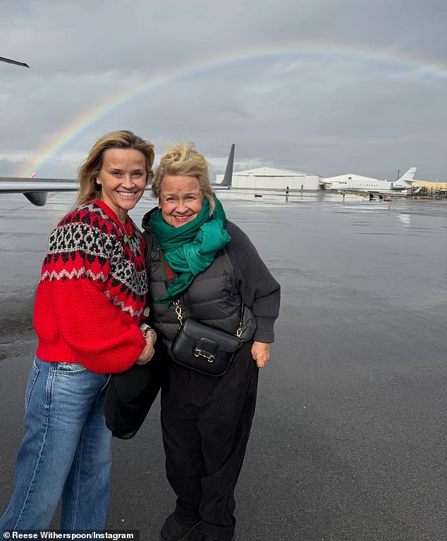 The You're Cordially Invited producer-star also posed beneath a rainbow with her nurse mother Betty (R)