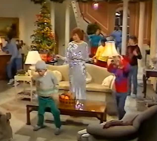 Doing his own thing: The boy in the beanie appears lost to the music, as Cilla is seen dancing behind him