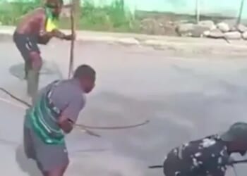 Shocking moment bow and arrow fight erupts in the middle of busy street between rival tribes using ancient weapons