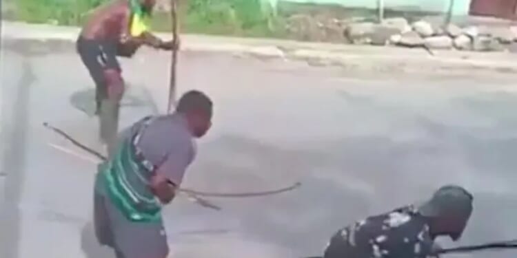 Shocking moment bow and arrow fight erupts in the middle of busy street between rival tribes using ancient weapons