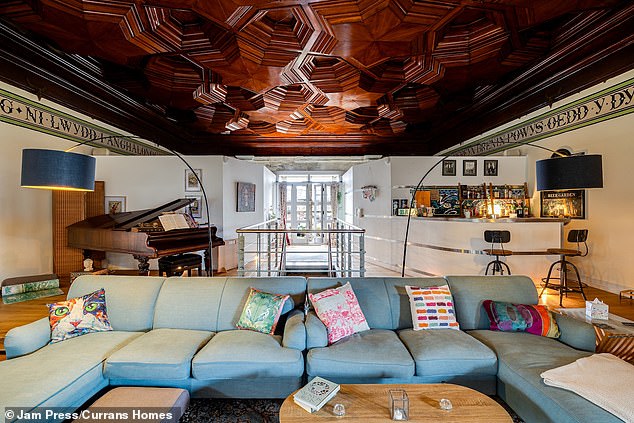 The cinema room has one of the most extraordinary carved ceilings and fringed by a Welsh-language frieze where it meets the walls