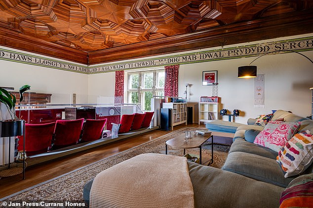 Back upstairs, the cinema is fitted with vintage red velvet cinema chairs