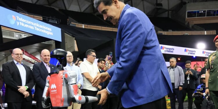 Awkward moment Venezuela tyrant Maduro salsas with robot as US flies special operations troops into Caribbean