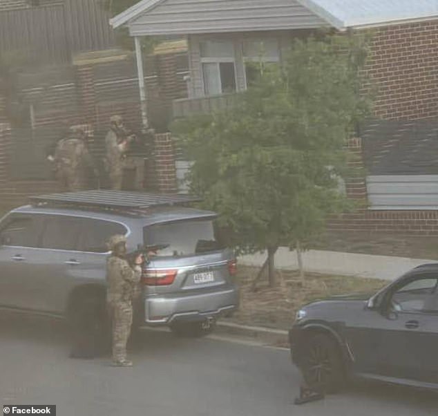 Several armed police officers (pictured) were spotted on Hazel Hawkes Avenue