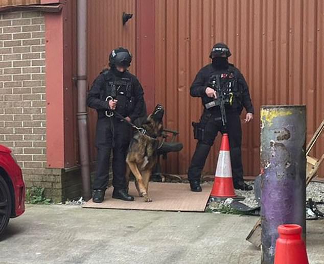 The operation was overseen by heavily armed police who waited outside with sub-machine guns and fearsome dogs