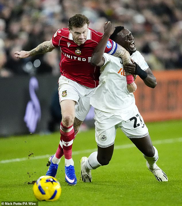 Wrexham's James McClean and Swansea City's Zeidane Inoussa (right) battle for the ball during the Sky Bet Championship match at Swansea stadium on December 19