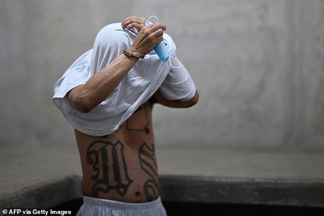 An inmate shows off his tattoos. While the mega prison has a capacity of 40,000, its director Belarmino Garcia declined to tell me how many prisoners are currently held there