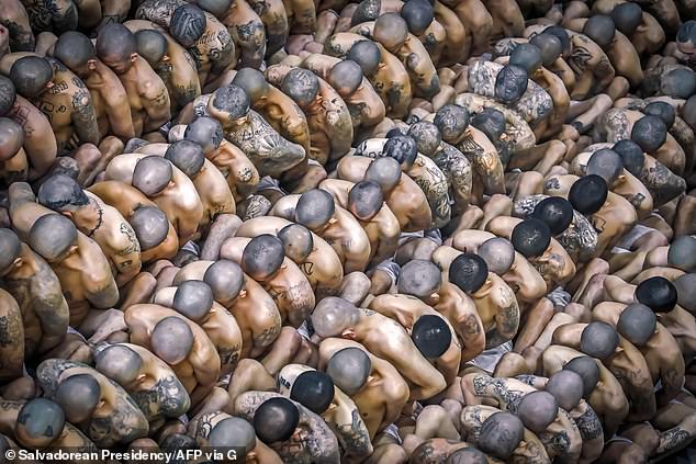 This picture shows inmates pressed against each other as they arrive at the grotesque facility