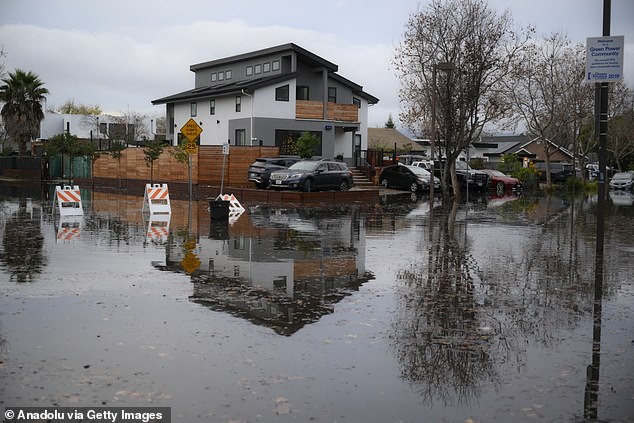 Storms began to move in late Tuesday evening and were expected to intensify throughout Christmas Eve, while a 'clipper' weather system is due to submerge much of the West Coast and Midwest in rain and snow on Christmas Day. (Pictured: Menlo Park, CA, on December 24)