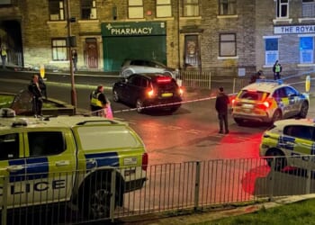 Man suffers 'life-changing' injuries after he was shot in the leg on residential street as cops launch urgent probe