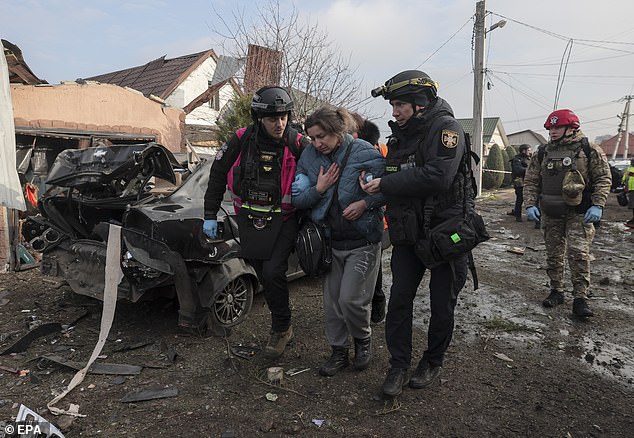 He suggested creating a demilitarised zone in the east of his country in a bid to speed up marathon peace plan negotiations with US officials in Florida. Pictured: Paramedics and police psychologists help residents at the site of a Russian strike on Ukraine on December 19, which left several injured