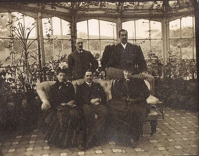 A vintage picture taken of the Hopwood family in the conservatory of the house