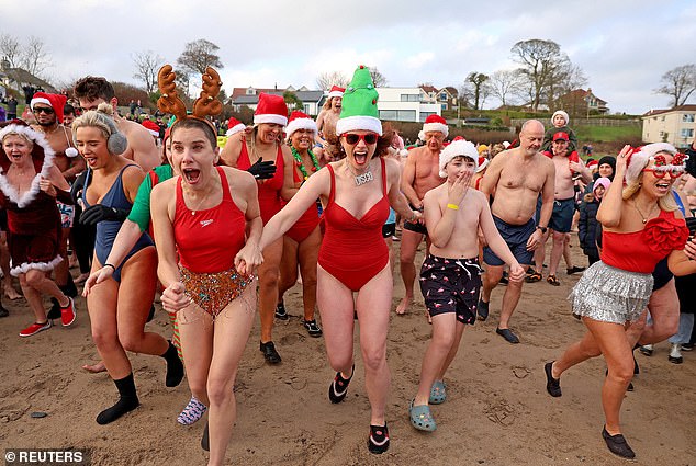 Crowds at Helen's Bay bracing for their cold plunge in the ocean on Christmas Eve