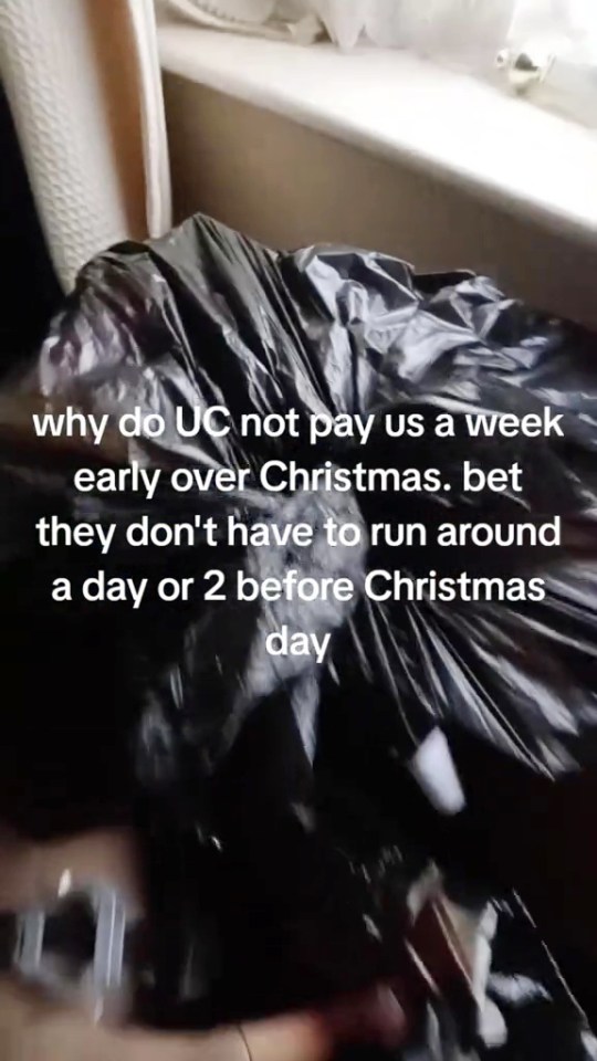 A video of a black trash bag with white text overlay lamenting not receiving early Christmas pay.