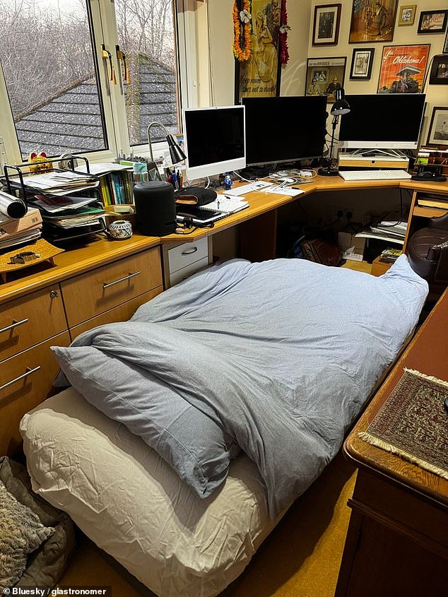 One unlucky lad is set to sleep, for several nights, wedged in next to a corner desk, with an inexplicable number of monitors sat atop it (pictured)