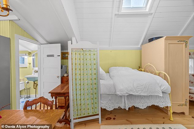 The tiny 'gingerbread home' has a bedroom that is separated from the rest of the property by a partition