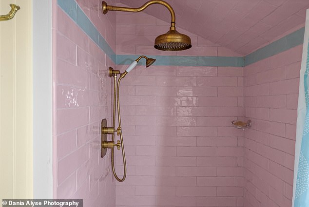 The freshly-tiled bathroom pairs butter-yellow walls with a shower dressed in a pink and blue design