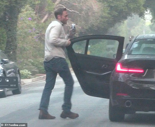 The two certainly seemed to be in the holiday spirit as they passed along a Christmaspresent on the outing together