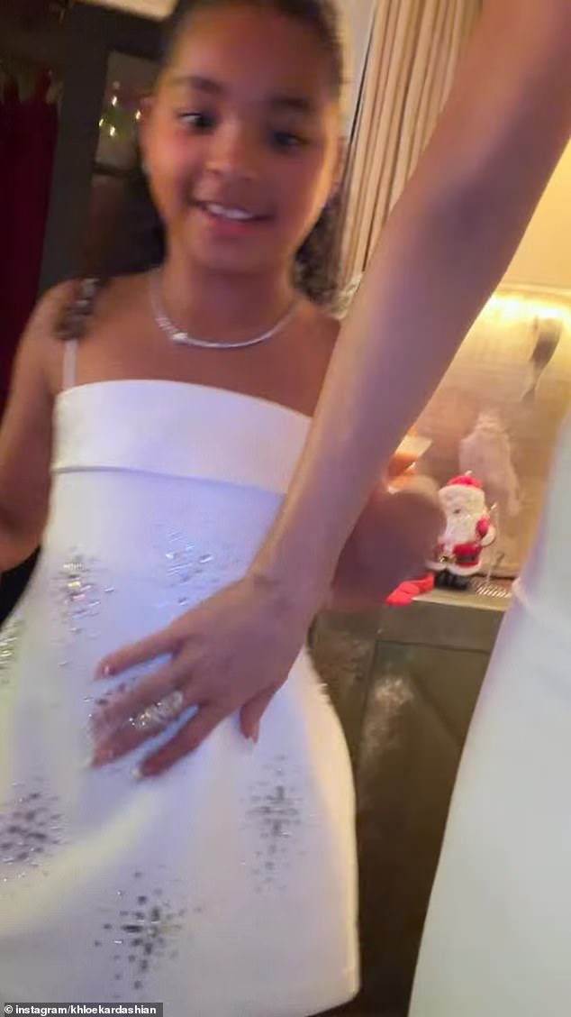 'No, True,' the star said while motioning for her daughter to stop doing the trend and then panned the camera to show True's white dress with shimmering silver embellishments