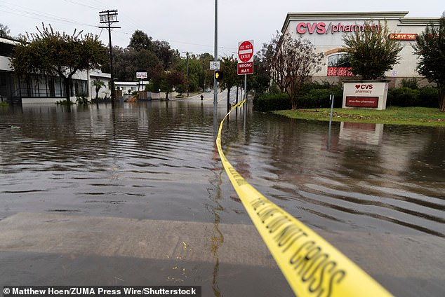 State of emergencies were declared in Los Angeles and Los Angeles County. Caution tape is seen in a flooded intersection in the South Pasadena area of LA