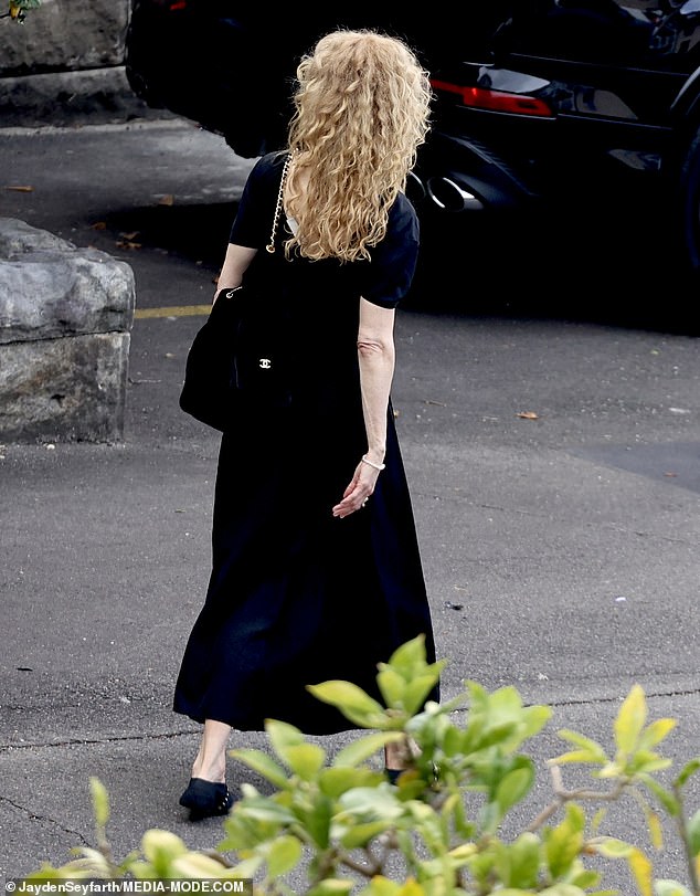 Nicole's natural curls added softness to the otherwise sombre look