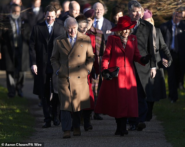 Camilla wore a festively red overcoat and stylish hat as she walked alongside King Charles