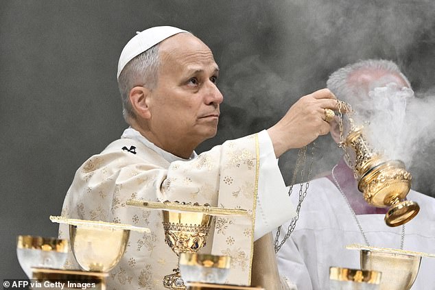 Pope Leo XIV holds an incent burner as he performs the Christmas mass at St Peter's Basilica