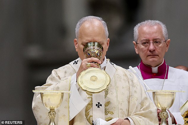 Pope Leo XIV drinks from a chalice as he celebrates Christmas Holy Mass