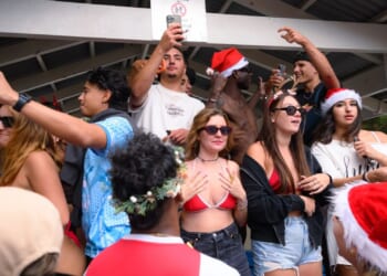 Thousands of revellers flood one of Australia's most popular beaches as backpackers in bikinis celebrate Christmas Day