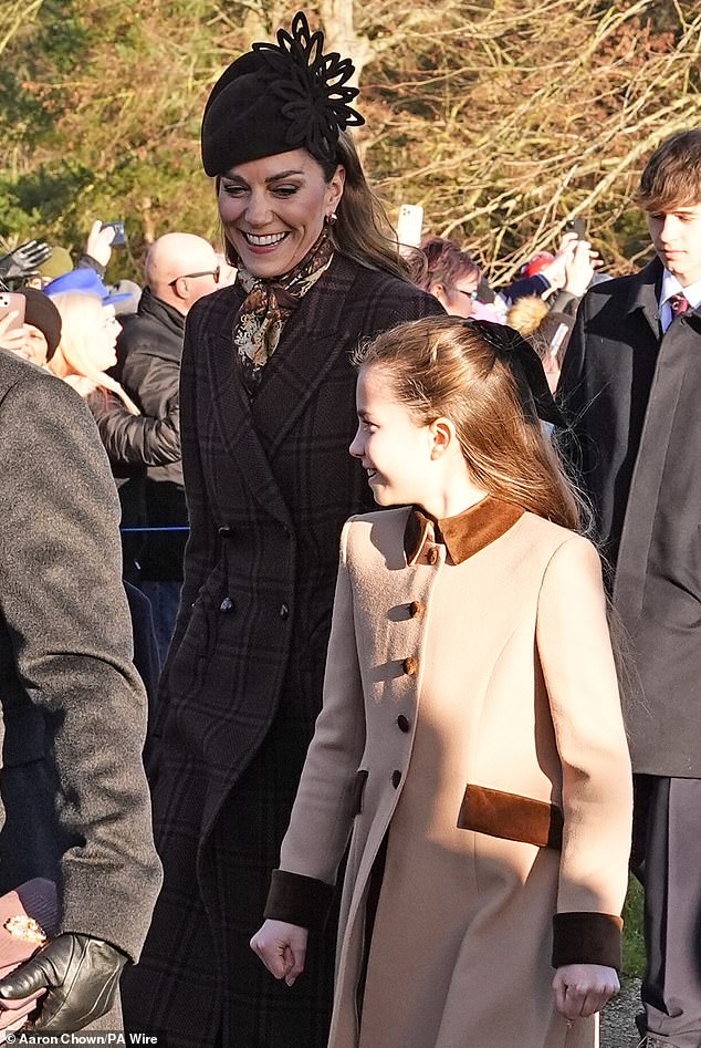 Catherine smiling sweetly at Charlotte after the pair surprised royal fans with a 'special' piano duet during the Together at Christmas carol concert