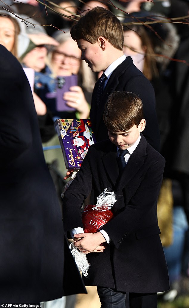 Prince George, 12, stopped to greet fans outside the church in Sandringham as Prince Louis kept one eye on the box of chocolates he received as a Christmas present