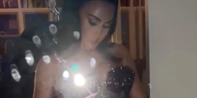 Kim Kardashian busts out of skintight silver gown as Kendall Jenner rocks shortest skirt ever for Christmas Eve bash