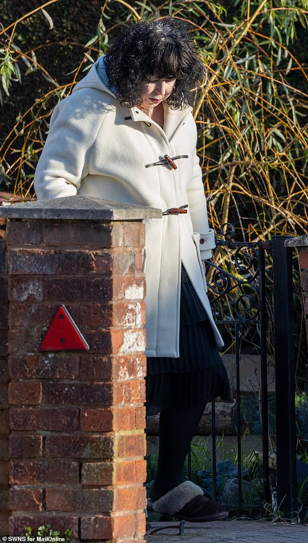 Caroline wrapped up warm in a white duffle coat while Mark got some fresh air to walk their family dog