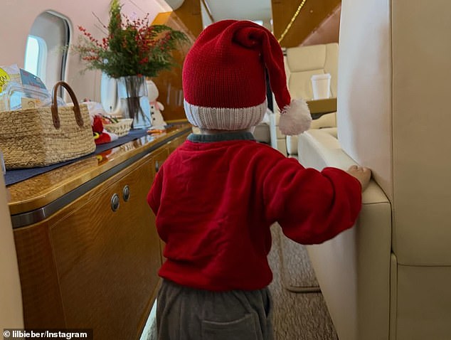 Justin Bieber's son Jack Blues got into the Christmas spirit with a cute Santa hat as he scampered about a private jet
