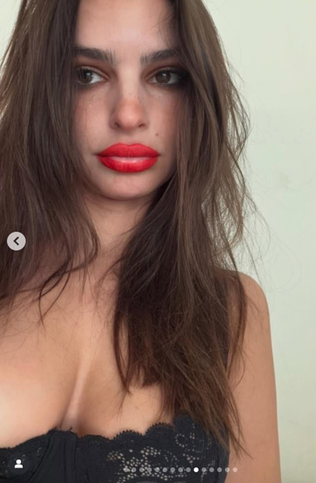 Emily Ratajkowski was seen with some missing red lipstick in a new post on Thursday. All she seemed to be wearing was a black lace bra