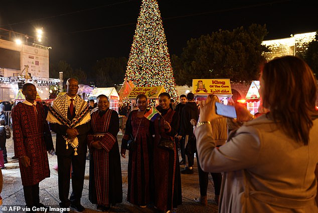 In Bethlehem, the Christian community celebrated its first festive Christmas in more than two years as the occupied West Bank city emerges from the shadow of the war. Hundreds of worshippers gathered for mass on Wednesday night at the church in Nativity Square (pictured)