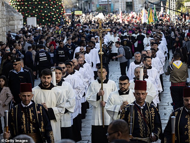 Members of the clergy take part in the Christmas procession led by Latin Patriarch of Jerusalem outside the Church of the Nativity on December 24, 2025 in Bethlehem