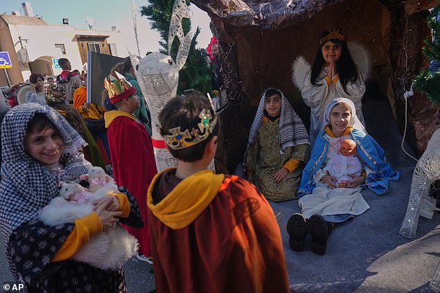 Wearing traditional costumes, children take part in the 40th annual Christmas parade heading towards the Basilica of the Annunciation in Nazareth, Israel, Wednesday, Dec. 24, 2025