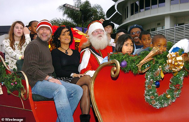 (L-R) Scout Willis, Bruce Willis, Victoria Rowell and Samuel L. Jackson pictured in 2003 at a holiday parade