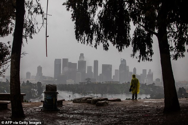 A man wearing a rain poncho walks at LA's Elysian Park
