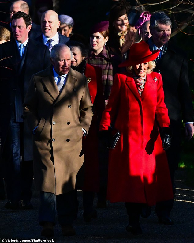 But Eugenie (centre), 35, smiled and beamed at the front of the group, along with her husband, Jack Brooksbank (left)