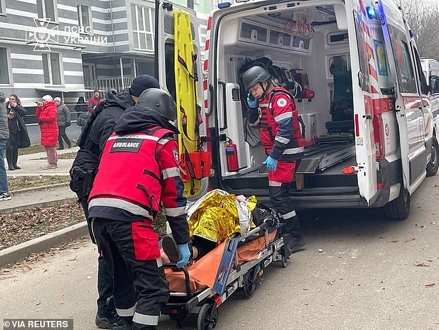 Emergency workers carry an injured resident into an ambulance. Russia's intensified attacks in recent weeks have left dozens dead and many others injured