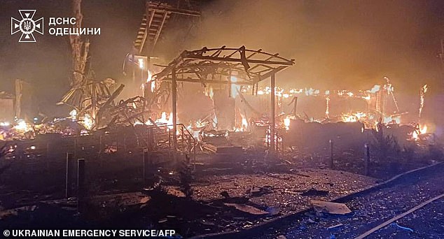 A damaged building on fire after Russia launched attacks on Ukraine yesterday