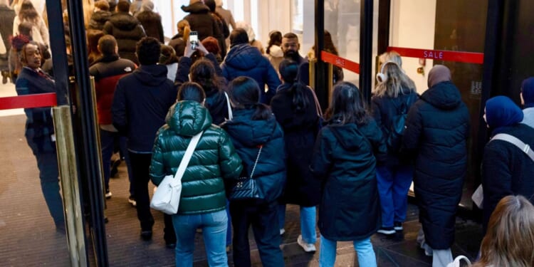 Bargain hunting Brits queue outside shopping centres & pack out stores across the UK for Boxing Day sales